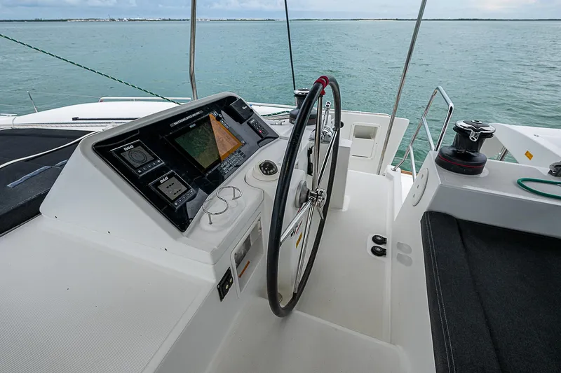Somewhere Yacht Photos Pics Lagoon 450 catamaran helm with navigation equipment, 2018 model, on calm waters.