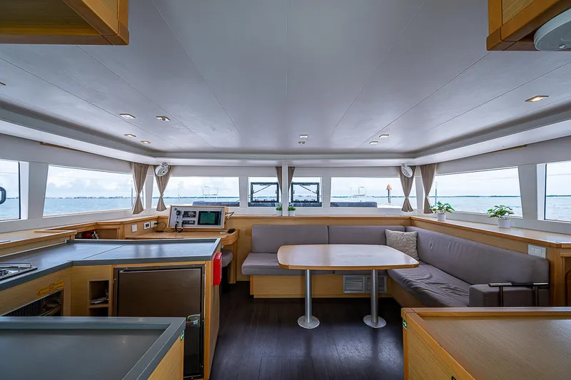 Somewhere Yacht Photos Pics Spacious interior of 2018 Lagoon 450 catamaran with modern seating and panoramic windows.