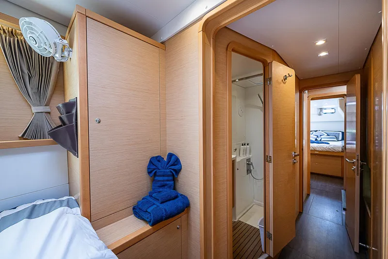 Somewhere Yacht Photos Pics Luxurious interior of 2018 Lagoon 450 catamaran with cozy cabin and modern bathroom.
