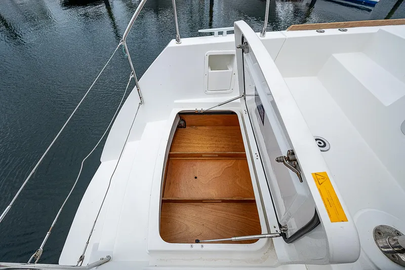 Somewhere Yacht Photos Pics Lagoon 450 yacht storage compartment, open, showing wooden interior, 2018 model.