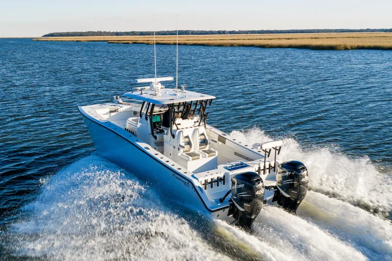  Yacht Photos Pics 2023 Freeman 34VH boat cruising on open water with twin Mercury engines.