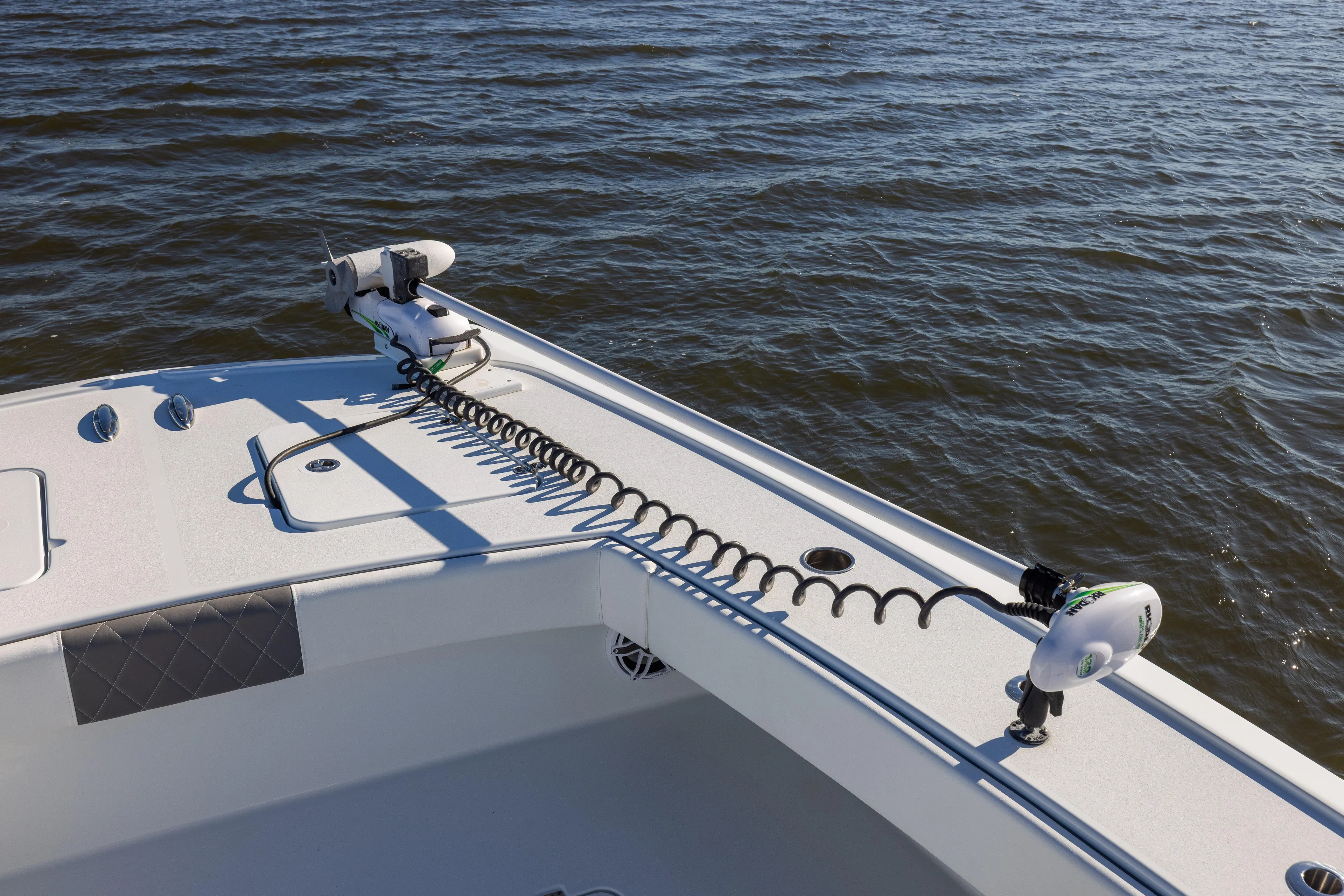  Yacht Photos Pics 2023 Freeman 34VH boat deck with trolling motor on calm water.