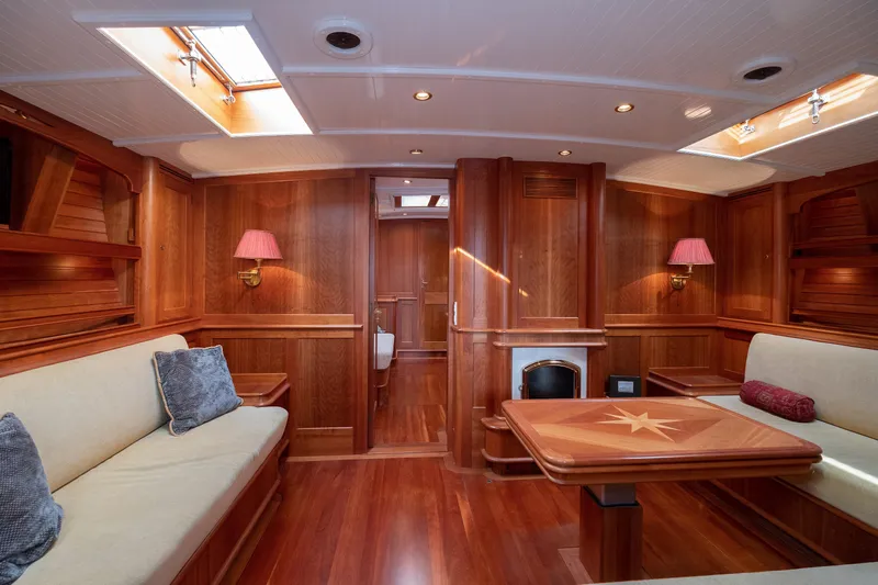 Dixbay Yacht Photos Pics Luxurious wooden interior of 2004 Hoek Classic 73 yacht with elegant seating and lighting.