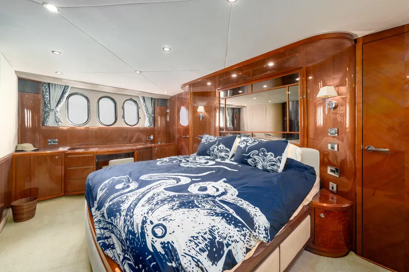 Ocaralia Yacht Photos Pics Luxurious 2008 Viking Princess 75 yacht bedroom with elegant wood paneling and nautical-themed bedding.