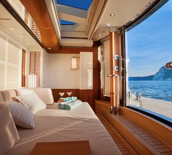 Belle Anna Yacht Photos Pics Luxurious ISA 500 yacht interior with ocean view, featuring elegant wood finishes and comfortable seating.