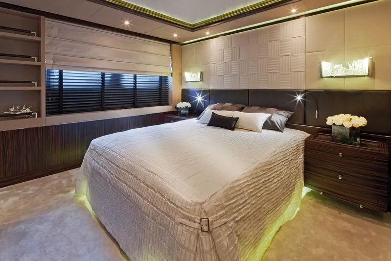 Belle Anna Yacht Photos Pics Luxurious bedroom on ISA 500 yacht, 2012 model, featuring elegant decor and ambient lighting.