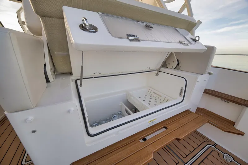  Yacht Photos Pics 2020 Boston Whaler 380 Realm boat cooler compartment with wooden deck accents.