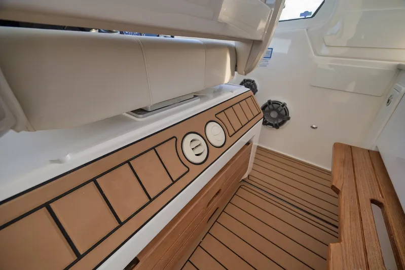  Yacht Photos Pics Interior of 2020 Boston Whaler 380 Realm with teak flooring and cushioned seating.