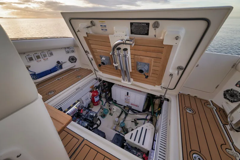  Yacht Photos Pics 2020 Boston Whaler 380 Realm engine compartment with open hatch, showcasing equipment and storage.