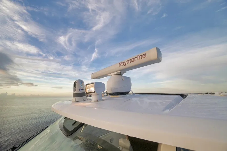  Yacht Photos Pics Boston Whaler 380 Realm 2020 with Raymarine radar against a scenic ocean backdrop.