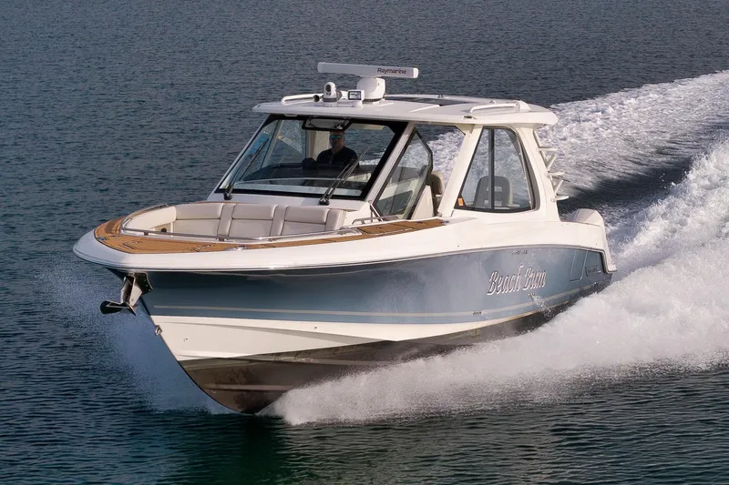  Yacht Photos Pics 2020 Boston Whaler 380 Realm cruising on water, showcasing sleek design and powerful performance.
