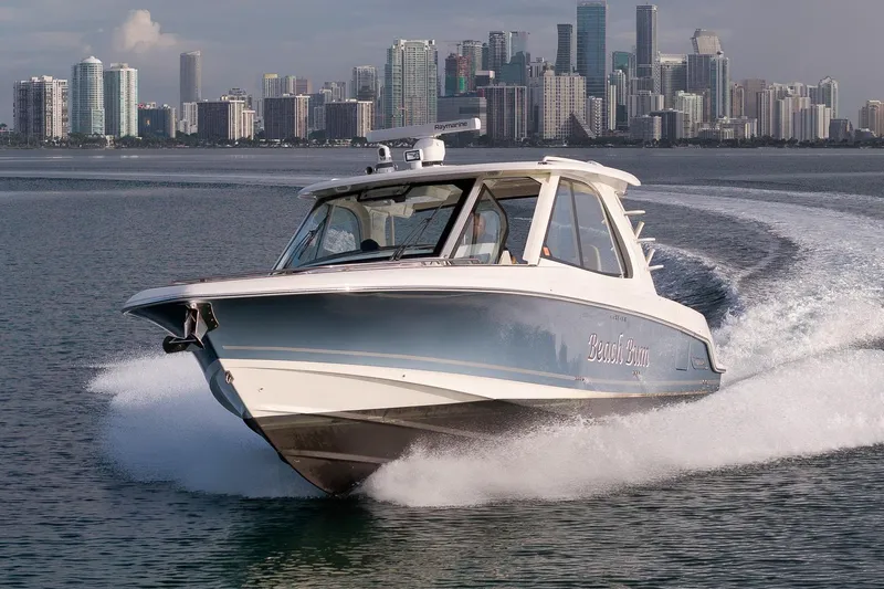  Yacht Photos Pics 2020 Boston Whaler 380 Realm cruising with city skyline in the background.