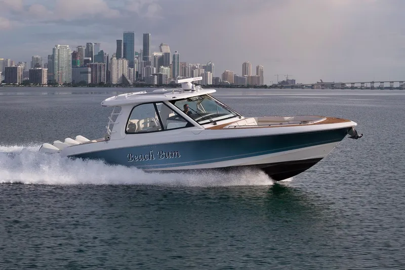  Yacht Photos Pics 2020 Boston Whaler 380 Realm cruising near city skyline on calm water.