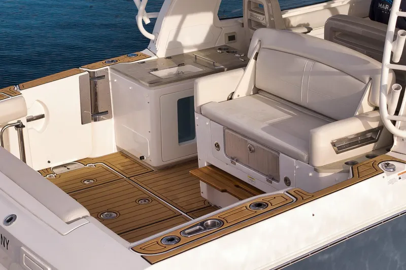  Yacht Photos Pics 2020 Boston Whaler 380 Realm boat interior with seating and teak flooring.
