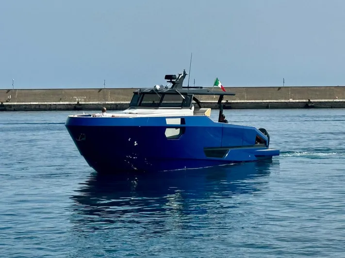  Yacht Photos Pics Aicon Audace 50 yacht, 2025 model, cruising in calm waters near a concrete pier.
