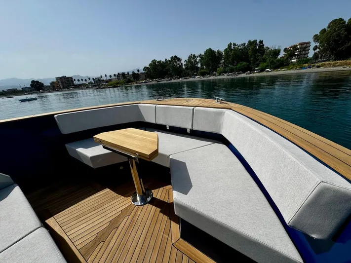  Yacht Photos Pics Luxurious Aicon Audace 50 yacht interior, 2025 model, with elegant seating and wooden table.