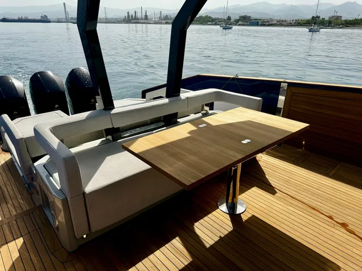  Yacht Photos Pics Aicon Audace 50 yacht deck with seating and table, 2025 model, on calm water.