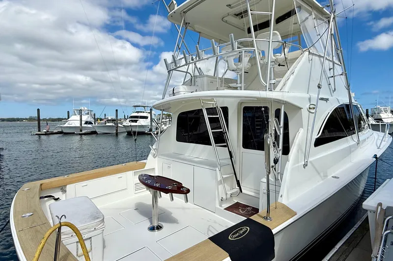  Yacht Photos Pics 2000 Ocean Yachts 48 docked, showcasing sleek design and spacious deck under a blue sky.