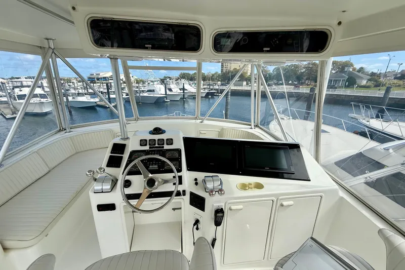  Yacht Photos Pics Helm of 2000 Ocean Yachts 48, featuring modern controls and panoramic marina view.