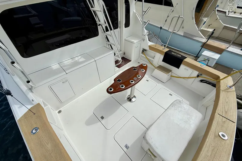  Yacht Photos Pics Spacious deck of a 2000 Ocean Yachts 48, featuring seating and fishing rod holders.