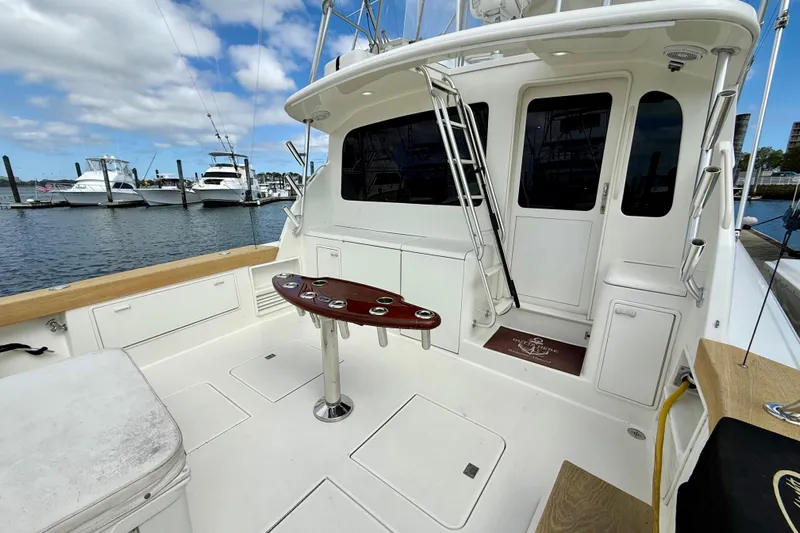  Yacht Photos Pics Ocean Yachts 48, 2000 model, featuring spacious deck and fishing amenities at marina.