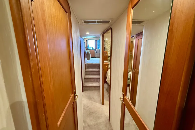  Yacht Photos Pics Hallway inside 2000 Ocean Yachts 48, featuring wooden doors and carpeted flooring.