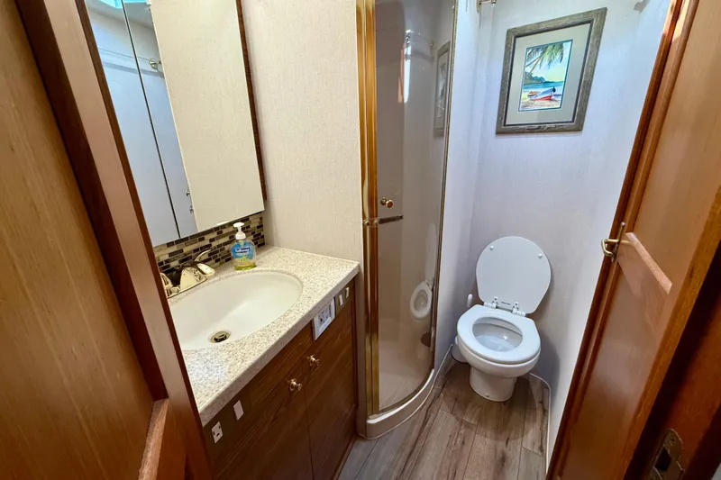  Yacht Photos Pics Bathroom interior of 2000 Ocean Yachts 48, featuring shower, sink, and toilet.