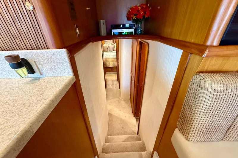  Yacht Photos Pics Interior view of 2000 Ocean Yachts 48, featuring a cozy staircase and elegant wood finishes.