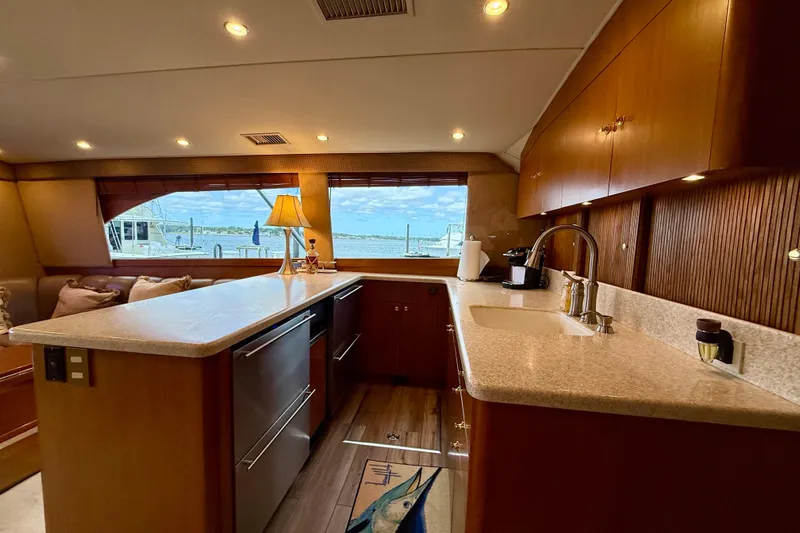  Yacht Photos Pics Luxurious interior of a 2000 Ocean Yachts 48, featuring a modern kitchen and scenic window view.