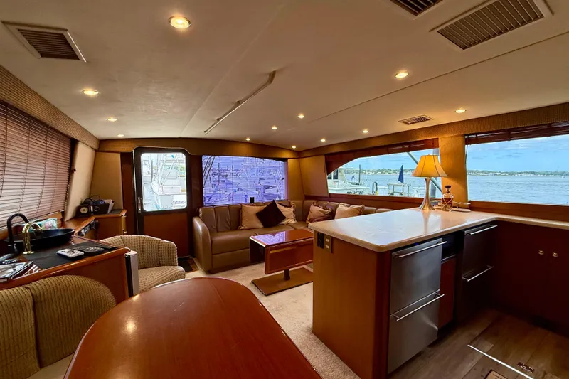  Yacht Photos Pics Luxurious interior of a 2000 Ocean Yachts 48, featuring a cozy seating area and scenic window views.
