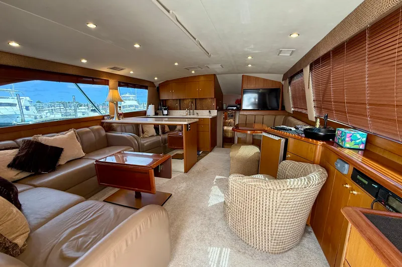  Yacht Photos Pics Luxurious interior of a 2000 Ocean Yachts 48, featuring plush seating and elegant wood finishes.
