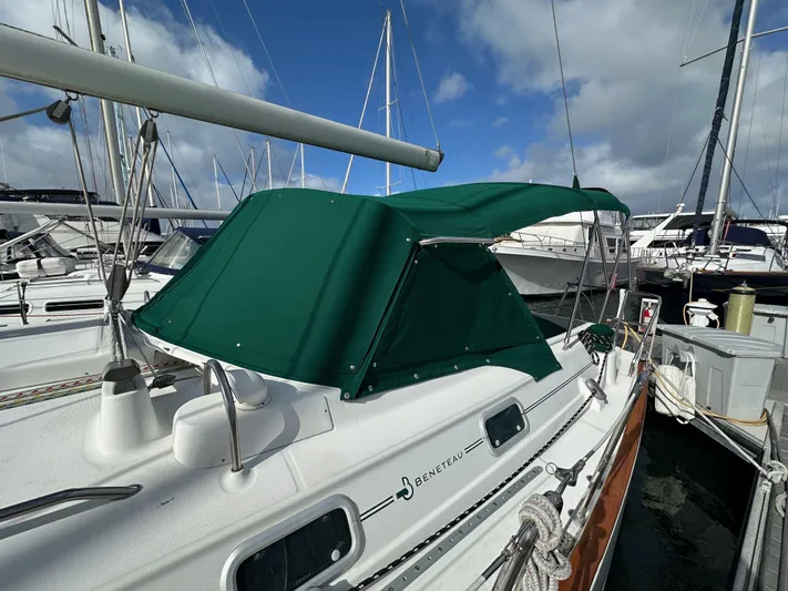 Knot Inspired Yacht Photos Pics 2002 Beneteau 411 sailboat with green canopy docked at marina.