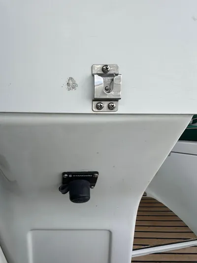 Knot Inspired Yacht Photos Pics Close-up of a 2002 Beneteau 411 yacht's deck detail, featuring a latch and socket.