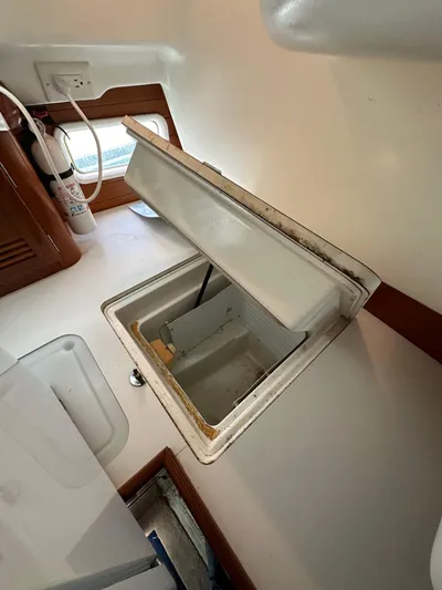 Knot Inspired Yacht Photos Pics Open storage compartment in 2002 Beneteau 411 sailboat interior.