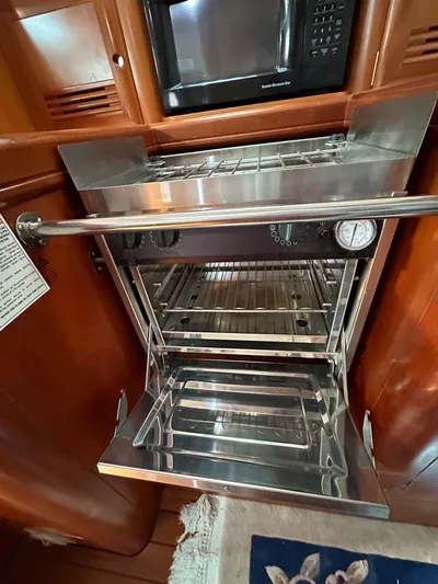 Knot Inspired Yacht Photos Pics Stainless steel oven in 2002 Beneteau 411 yacht kitchen interior.