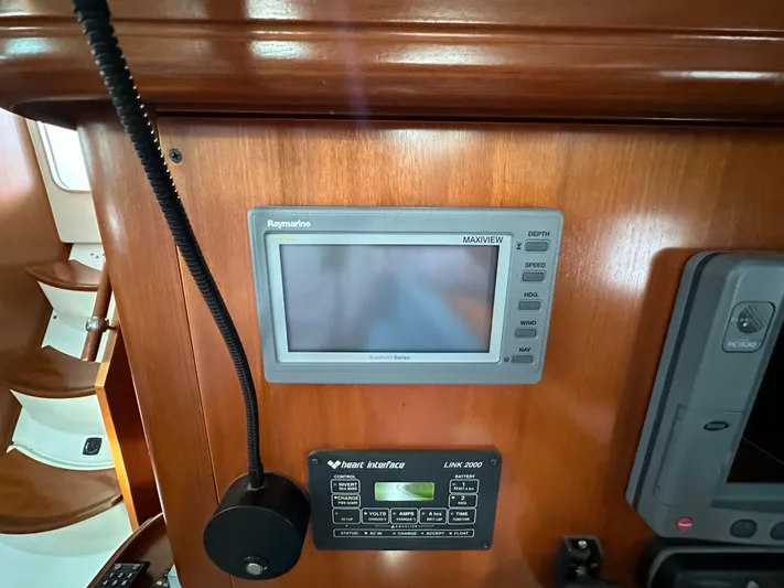 Knot Inspired Yacht Photos Pics Navigation equipment on 2002 Beneteau 411 yacht, featuring Raymarine display and marine radio.