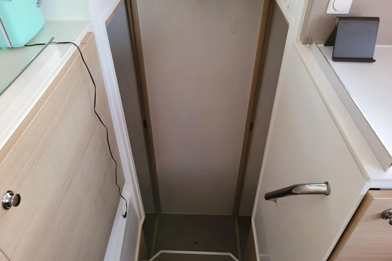  Yacht Photos Pics Narrow interior passageway on a 2019 Bali 4.3 catamaran, featuring modern cabinetry.
