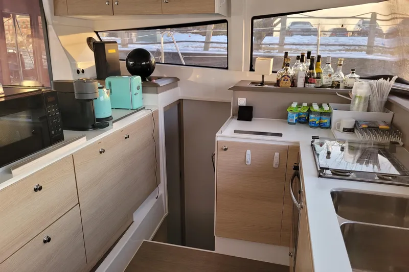  Yacht Photos Pics Modern kitchen interior on a 2019 Bali 4.3 yacht with appliances and beverages.