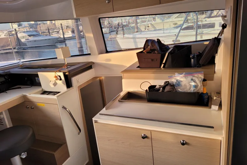  Yacht Photos Pics Interior of a 2019 Bali 4.3 catamaran with organized storage and marina view.