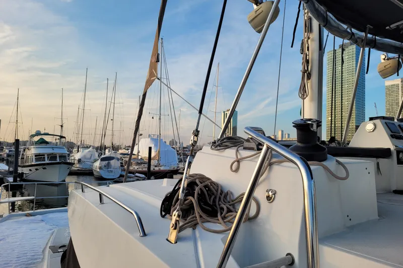  Yacht Photos Pics 2019 Bali 4.3 catamaran docked in marina with city skyline background.