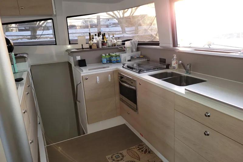  Yacht Photos Pics Modern kitchen interior of 2019 Bali 4.3 catamaran with appliances and sunlight through windows.
