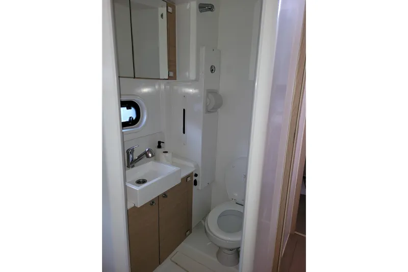  Yacht Photos Pics Compact bathroom in 2019 Bali 4.3 model, featuring sink, toilet, and storage cabinets.