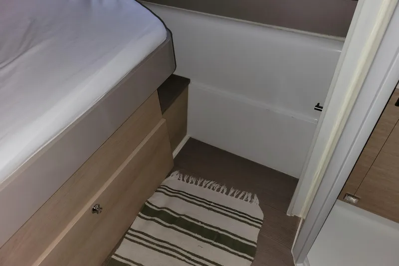  Yacht Photos Pics Interior of a 2019 Bali 4.3 yacht cabin with bed and striped rug.