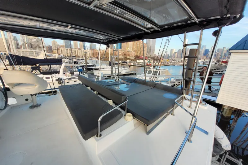  Yacht Photos Pics 2019 Bali 4.3 yacht with spacious deck, docked in urban marina setting.