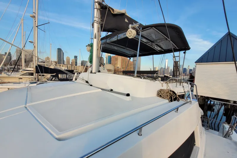  Yacht Photos Pics 2019 Bali 4.3 catamaran docked in urban marina with city skyline.