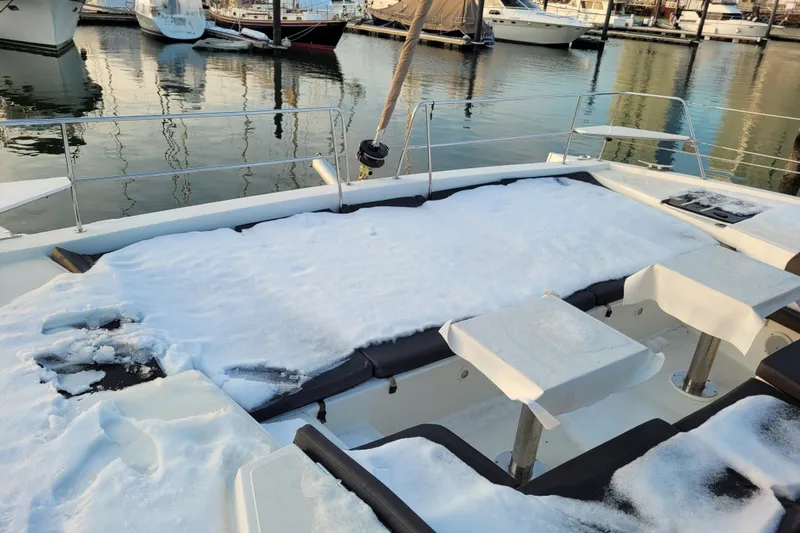 Yacht Photos Pics Snow-covered deck of a 2019 Bali 4.3 catamaran in a marina.