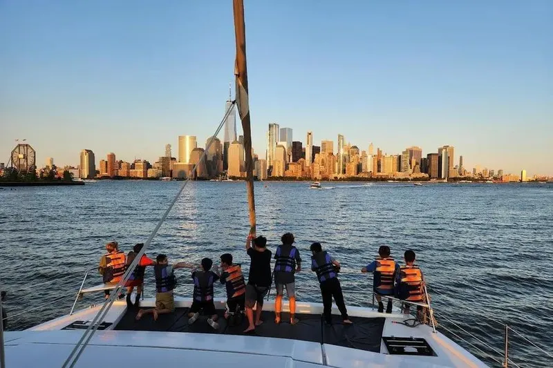  Yacht Photos Pics Children on a 2019 Bali 4.3 catamaran enjoying a city skyline view at sunset.