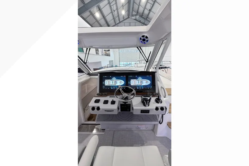  Yacht Photos Pics 2026 Regal 38 SAV boat cockpit with dual screens and modern controls.