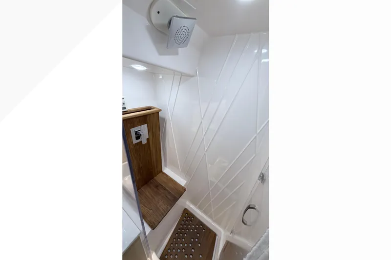  Yacht Photos Pics Luxurious shower area in 2026 Regal 38 SAV boat with modern fixtures and wooden accents.