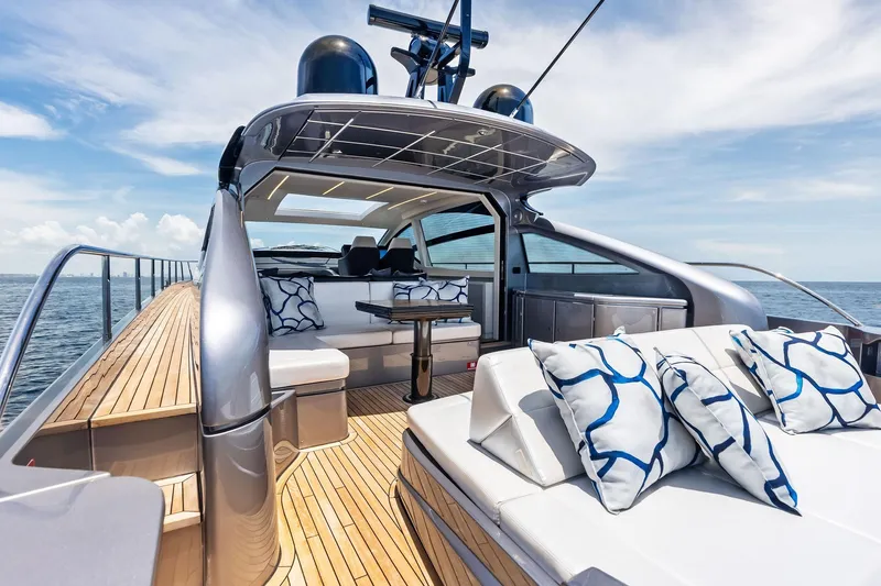  Yacht Photos Pics Luxurious 2024 Pershing 6X yacht with elegant deck and stylish seating, cruising on open water.